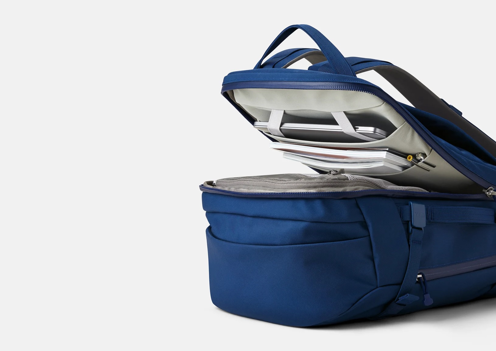 the yeti crossroads 35 liter backpack clamshell opening allows easy access to cargo area and laptop compartment.