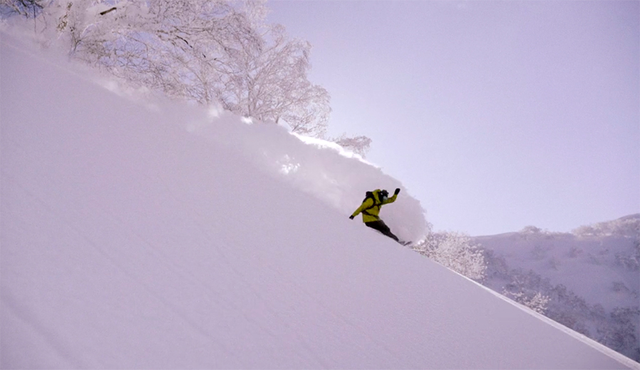 Alex Yoder makes a big turn on a snowboard in Japan