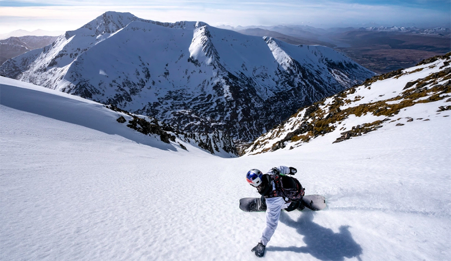 A snowboarder rips a line in the Scottish Highlands
