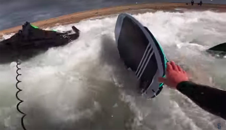 A wing foiler gets beat down in the shorebreak