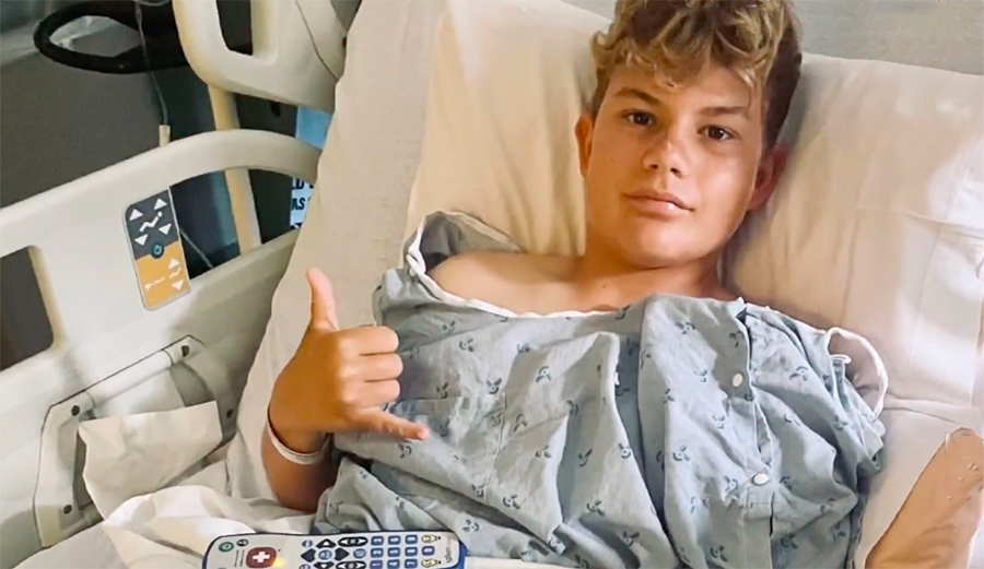 Parker Blanchette in a hospital bed after getting bitten by a shark