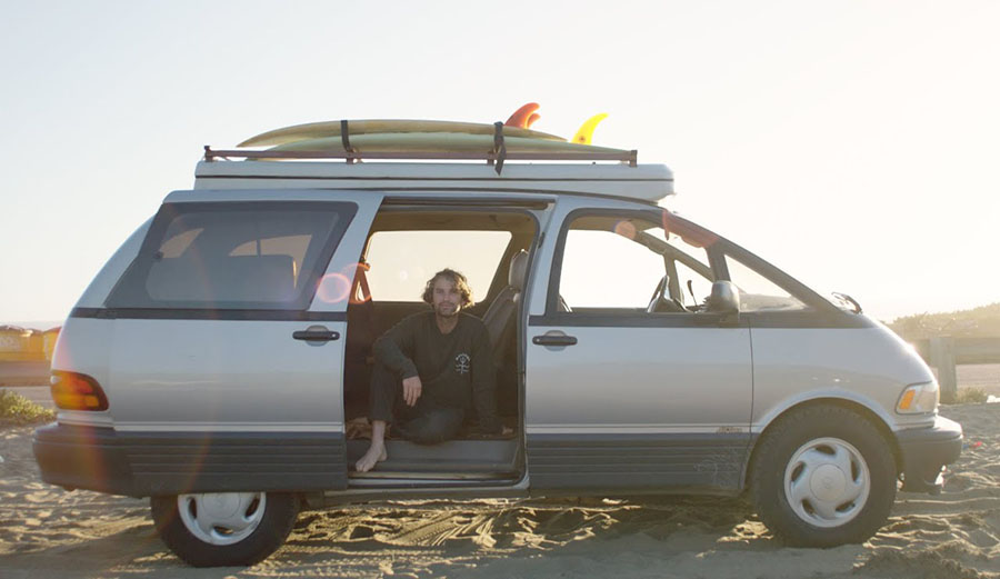 Jay Nelson sits in his pop-top camper