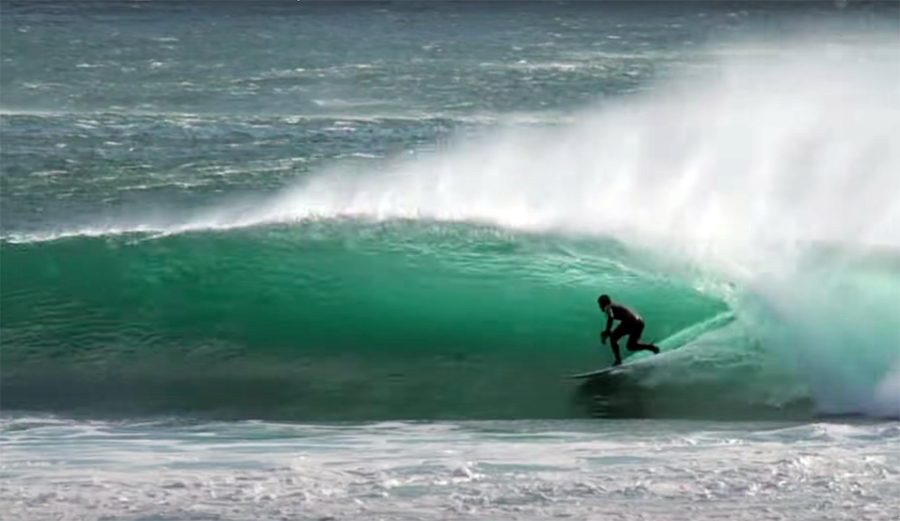 A surfer rides a barrel on Vancouver Island