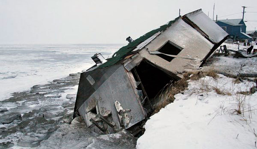 An abandoned house sits on a beach after a storm in Shishmaref, Alaska