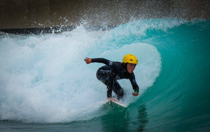 grom at The Wave in Bristol with a helmet on getting barreled