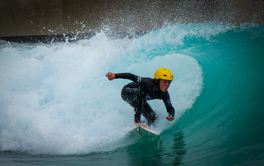 grom at The Wave in Bristol with a helmet on getting barreled