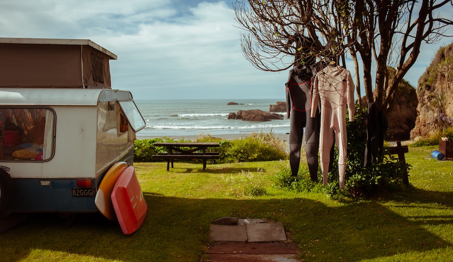 wetsuits hanging at a campsite