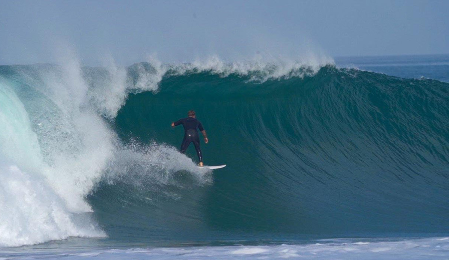 A surfer pulls into a barrel in San Diego