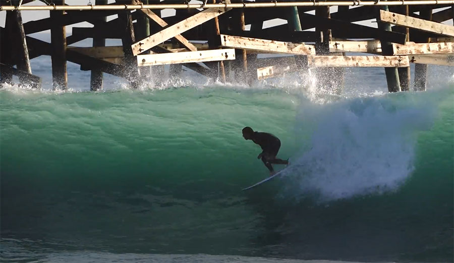 Mason Ho surfing the San Clemente Pier