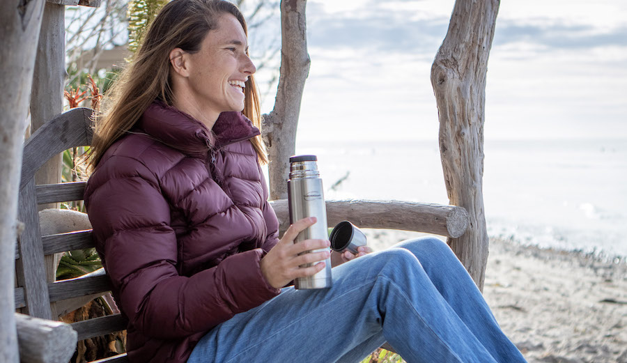a woman drinks out of one of the best insulated coffee mugs in this guide