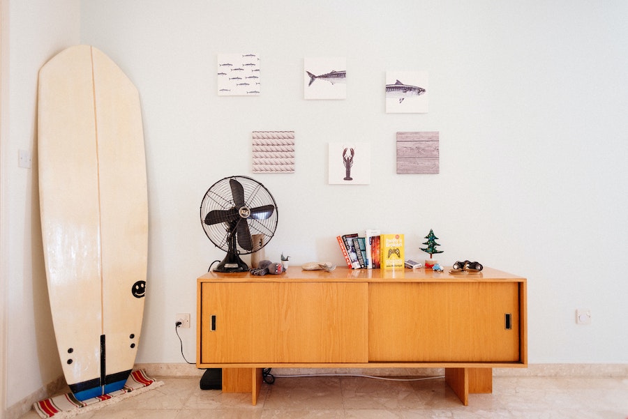 Surfboard repaired on wall