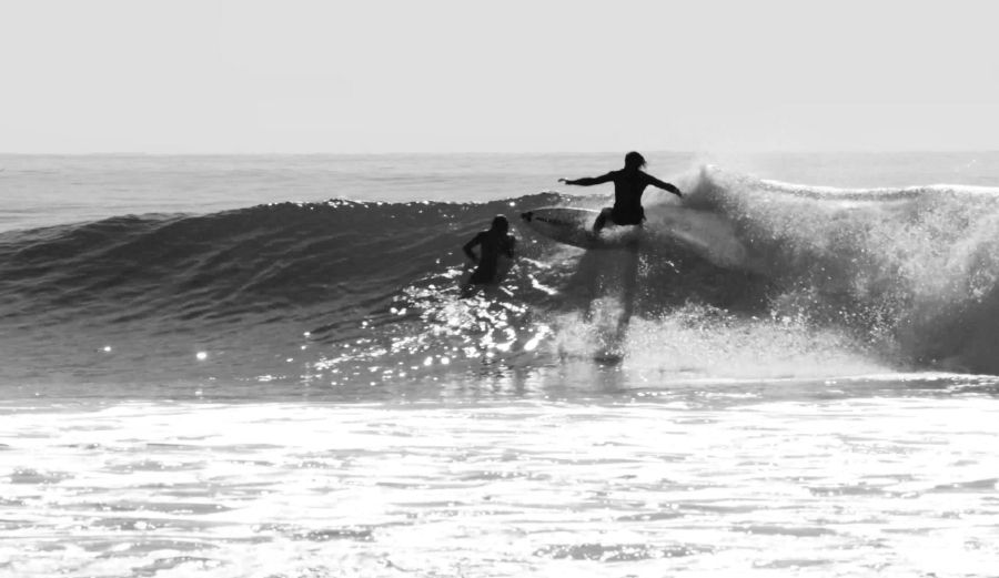 Rincon Surfers almost collide Human Boardslide