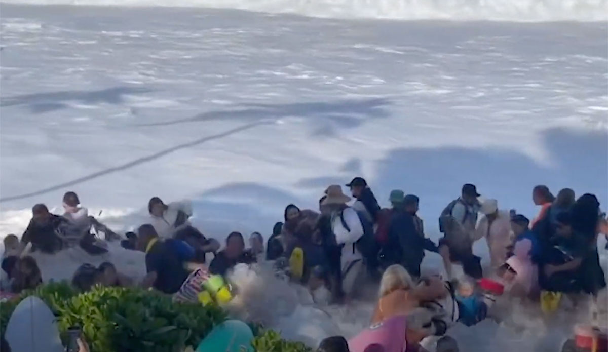 The Eddie big waves wash into crowd