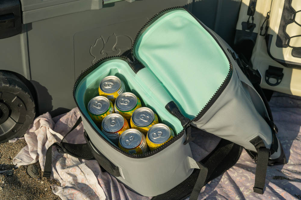 the pelican dayventure backpack cooler full of tall cans