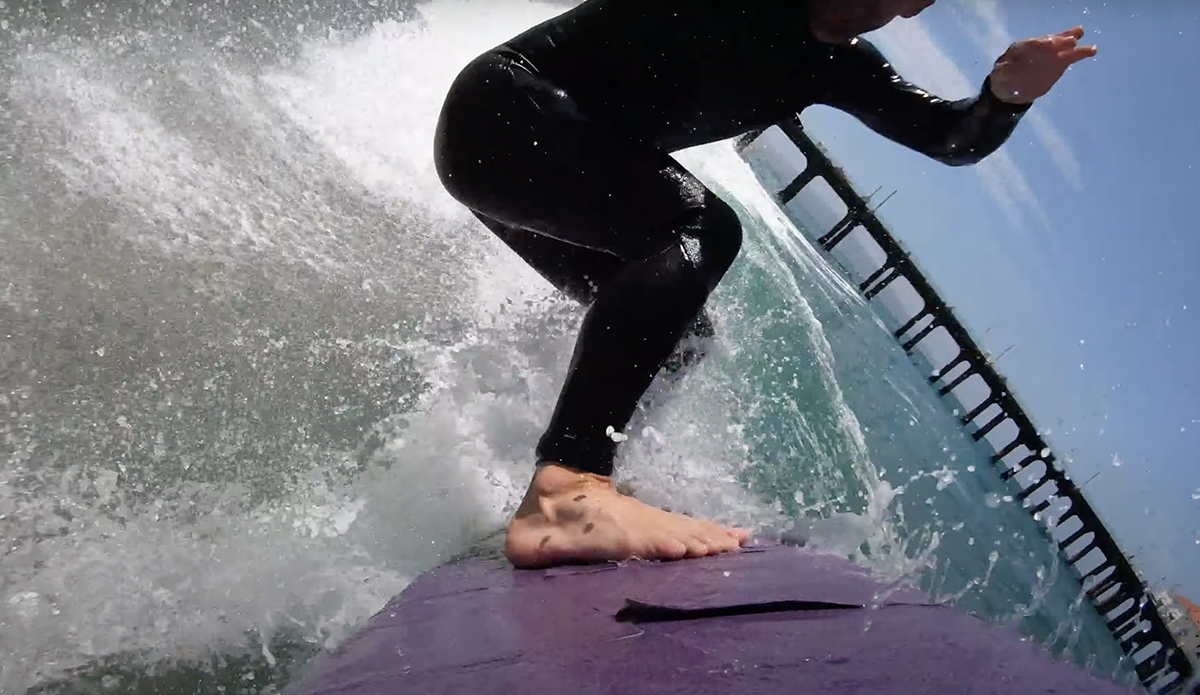 Travis Logie rides a sandpaper surfboard.
