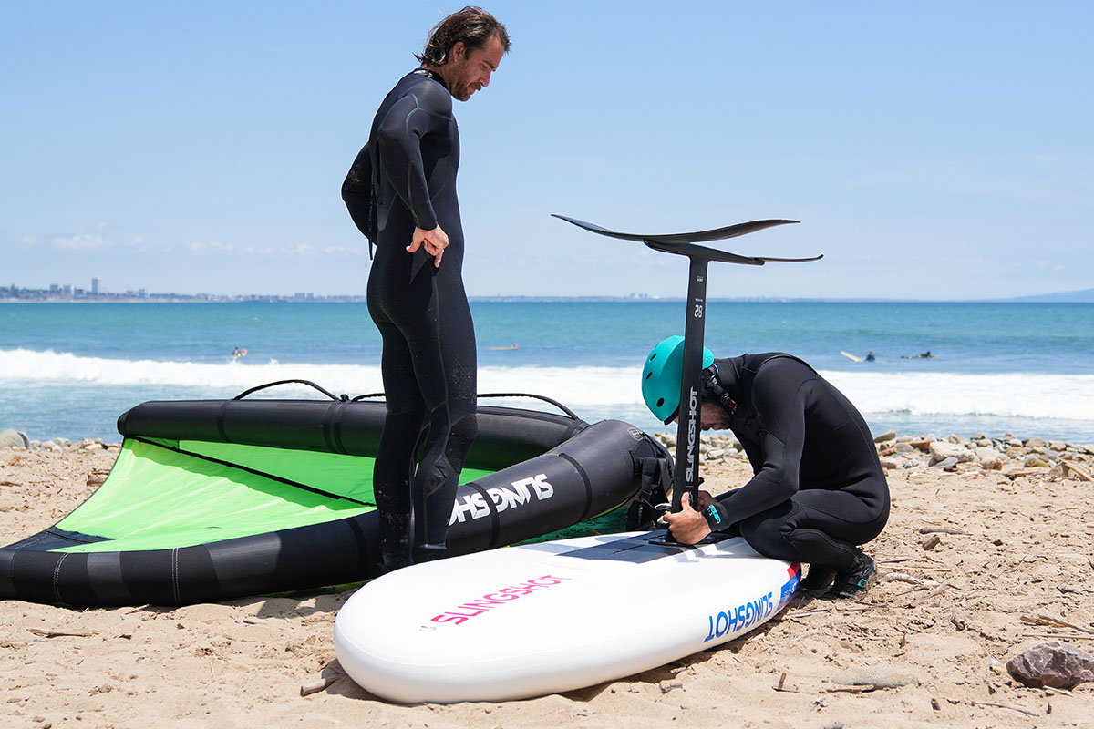 attaching a hydrofoil to the slingshot ltf board while on the beach