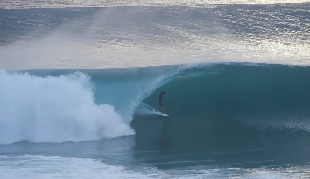 A surfer getting barreled at Growers in Desert Point.
