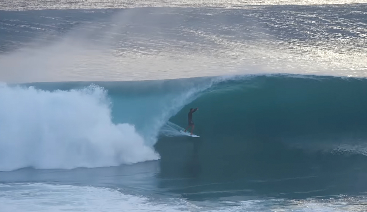 A surfer getting barreled at Growers in Desert Point.