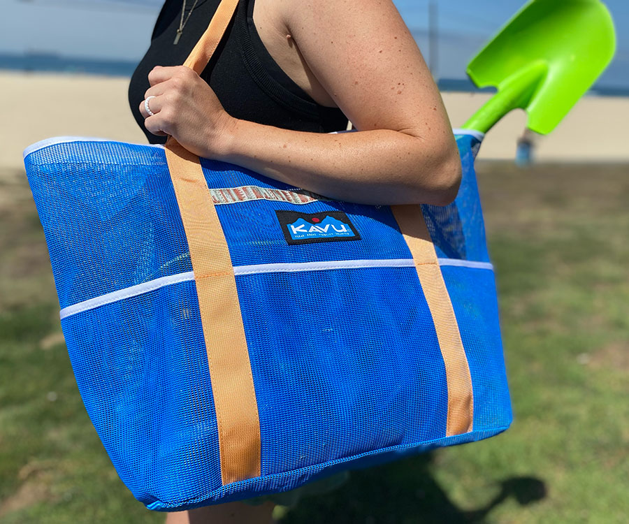 a photo of the kavu alder lake tote at the beach for our review of the best beach bags