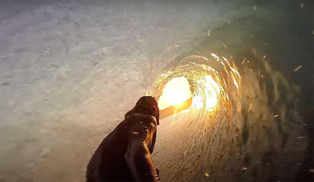 Mikala Jones surfing