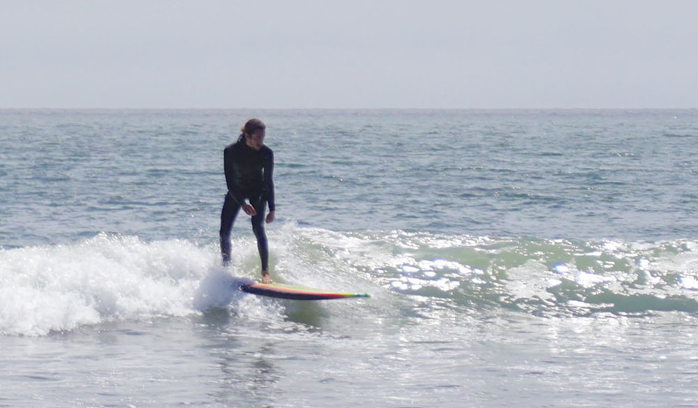 surfing small knee high waves on a wavestorm soft top surfboard while testing for our review.