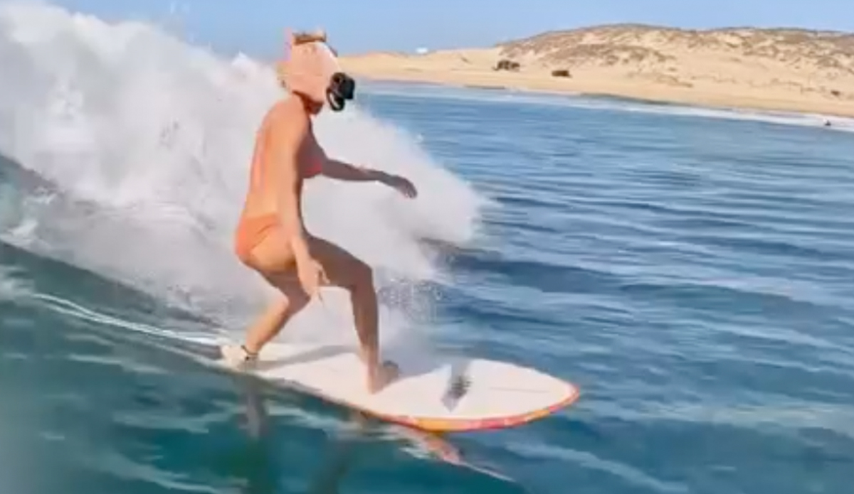 Ivy Miller surfs in a horse head mask.