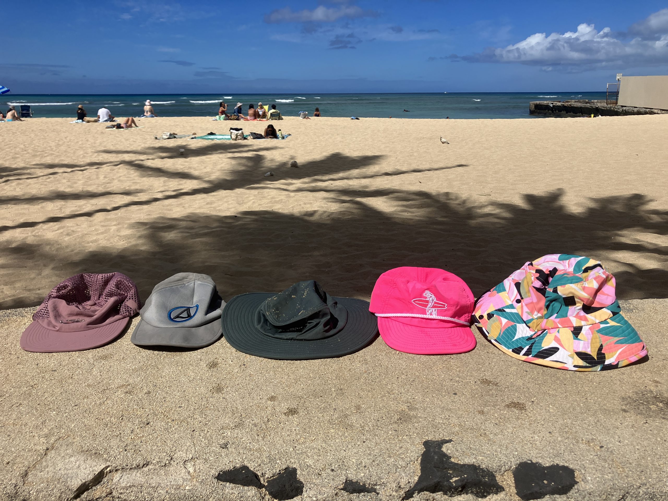 a line up of surf hats on the beach
