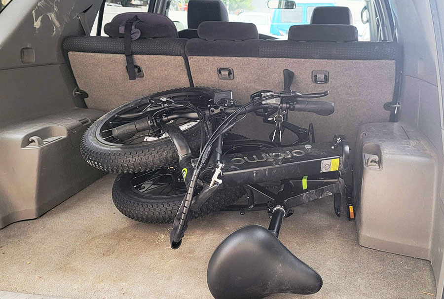 the Oriamo Scrambler 100 folded up in the back of an SUV