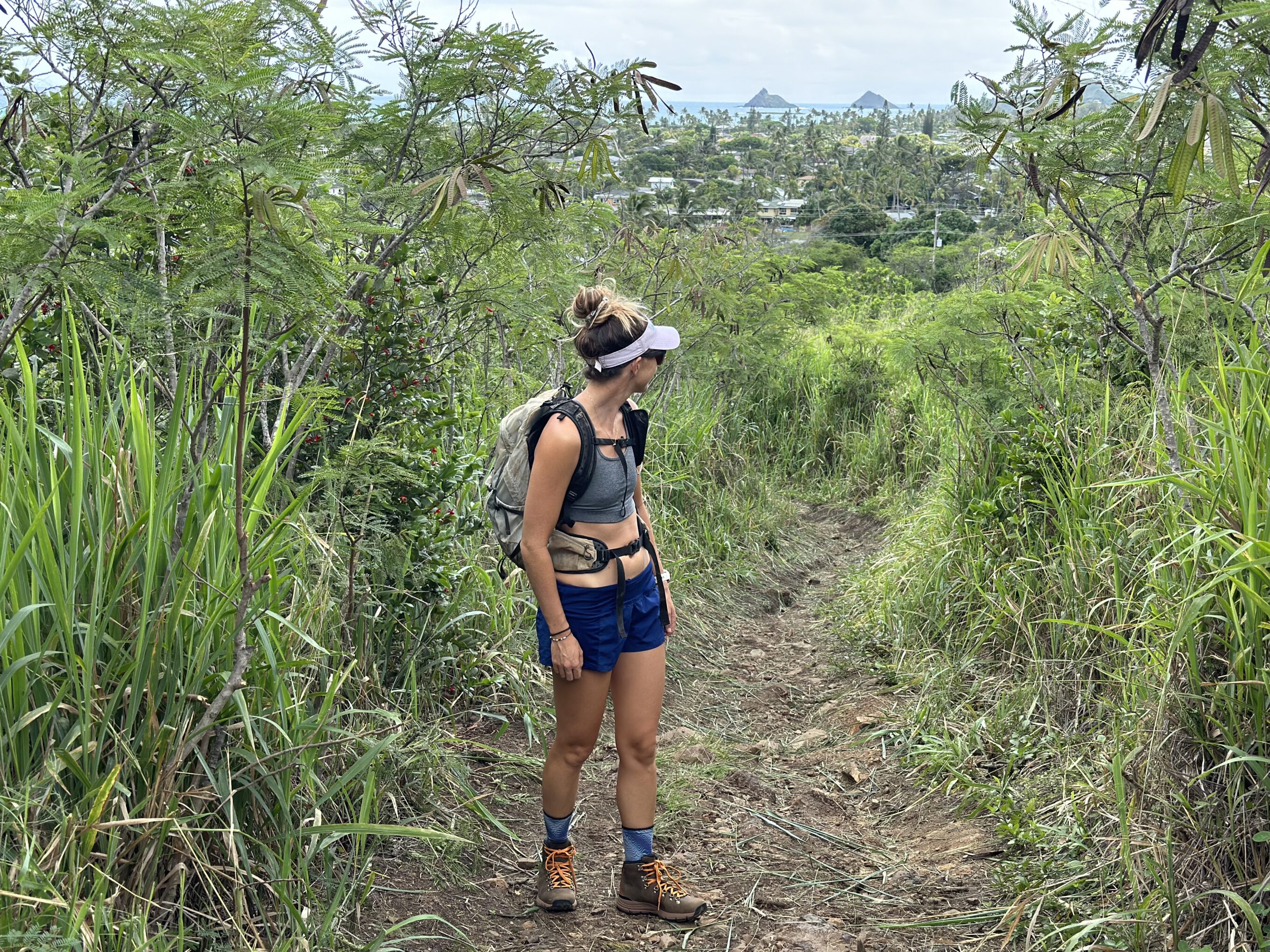 a woman hiking in a pair of hiking boots in a grassy area