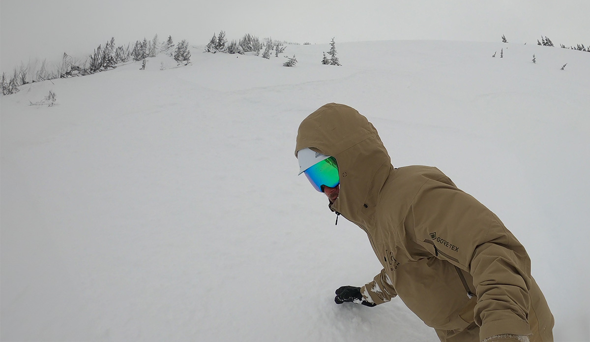 snowboarding in powder wearing the Smith 4D Mag goggles