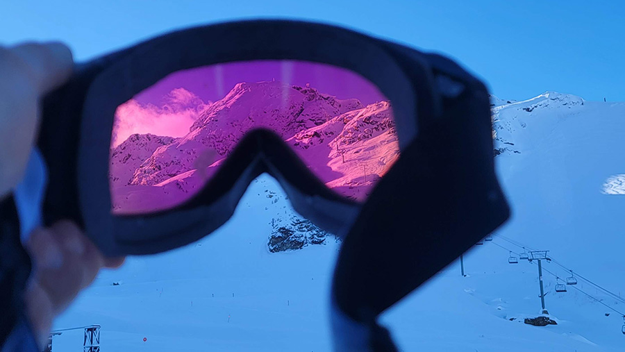 looking through a pair of smith optics 4d mag goggles to display the chromapop lens technology