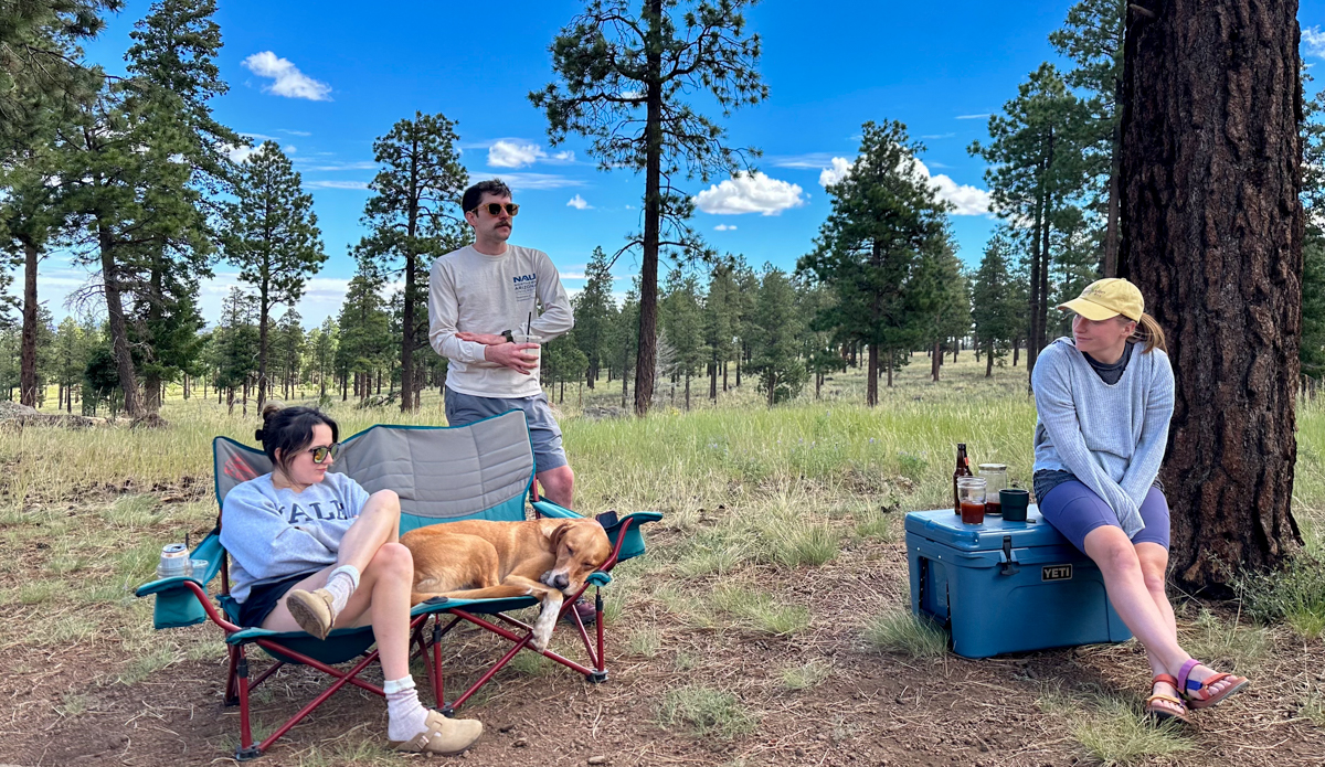 sitting in camping chair around site