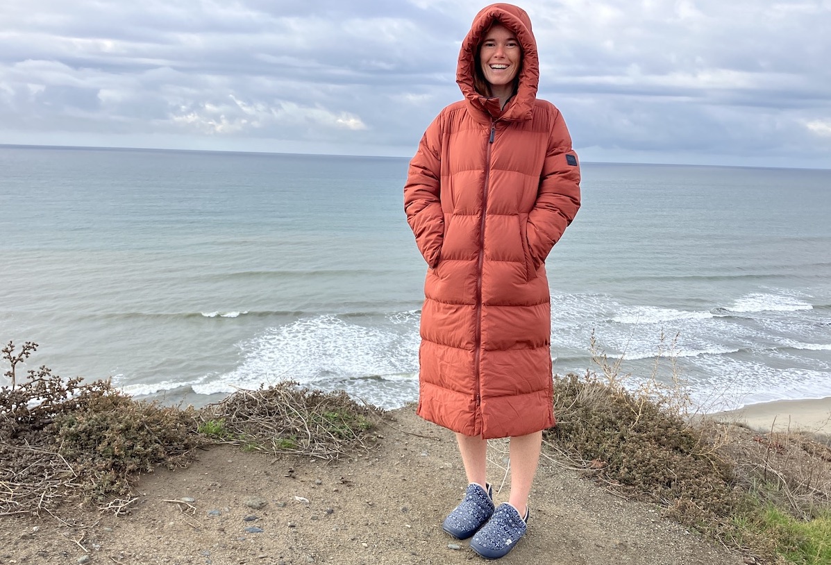 Women standing on the beach in a puffer jacket