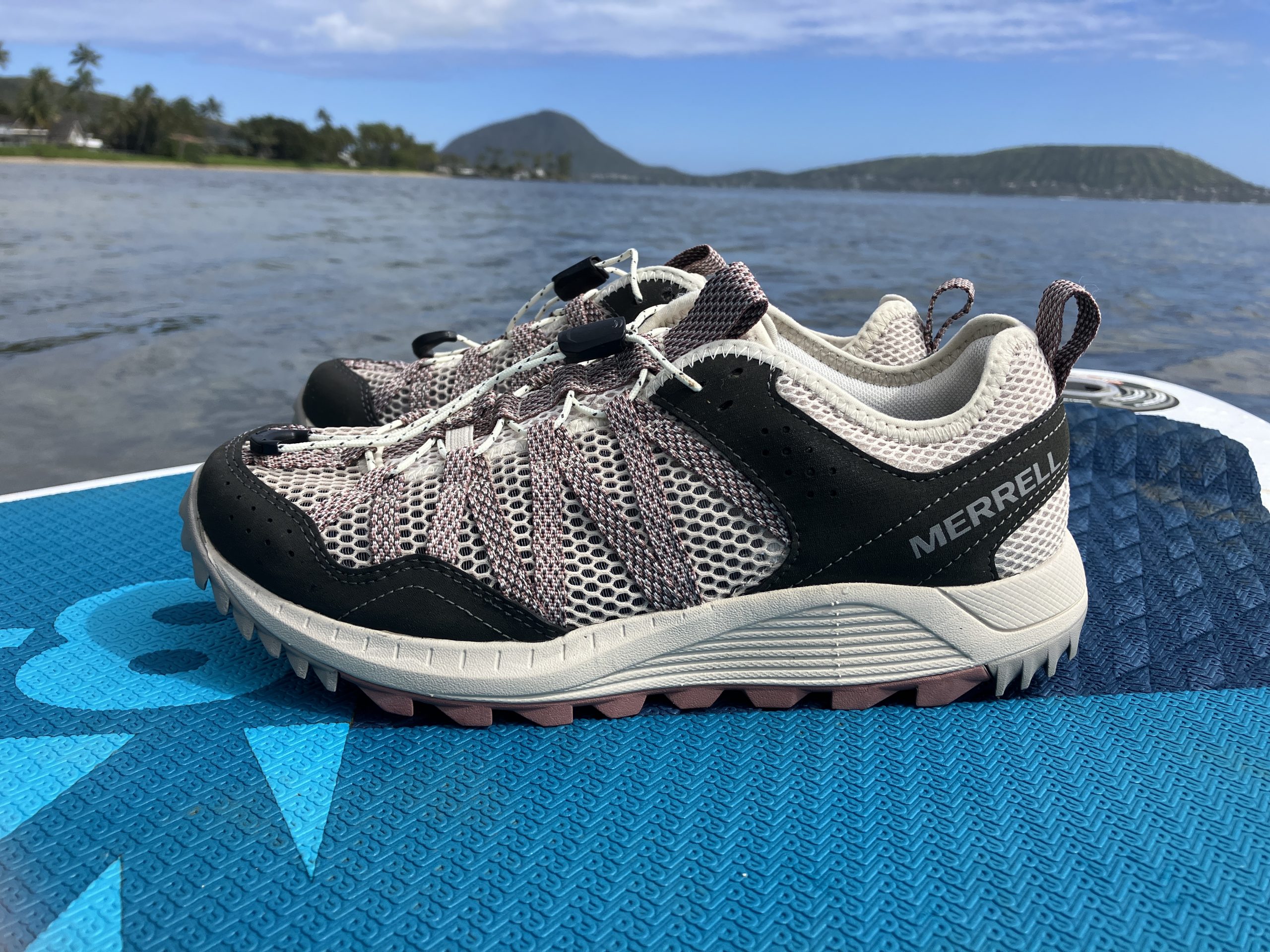 watershoes sitting on a paddleboard in the ocean