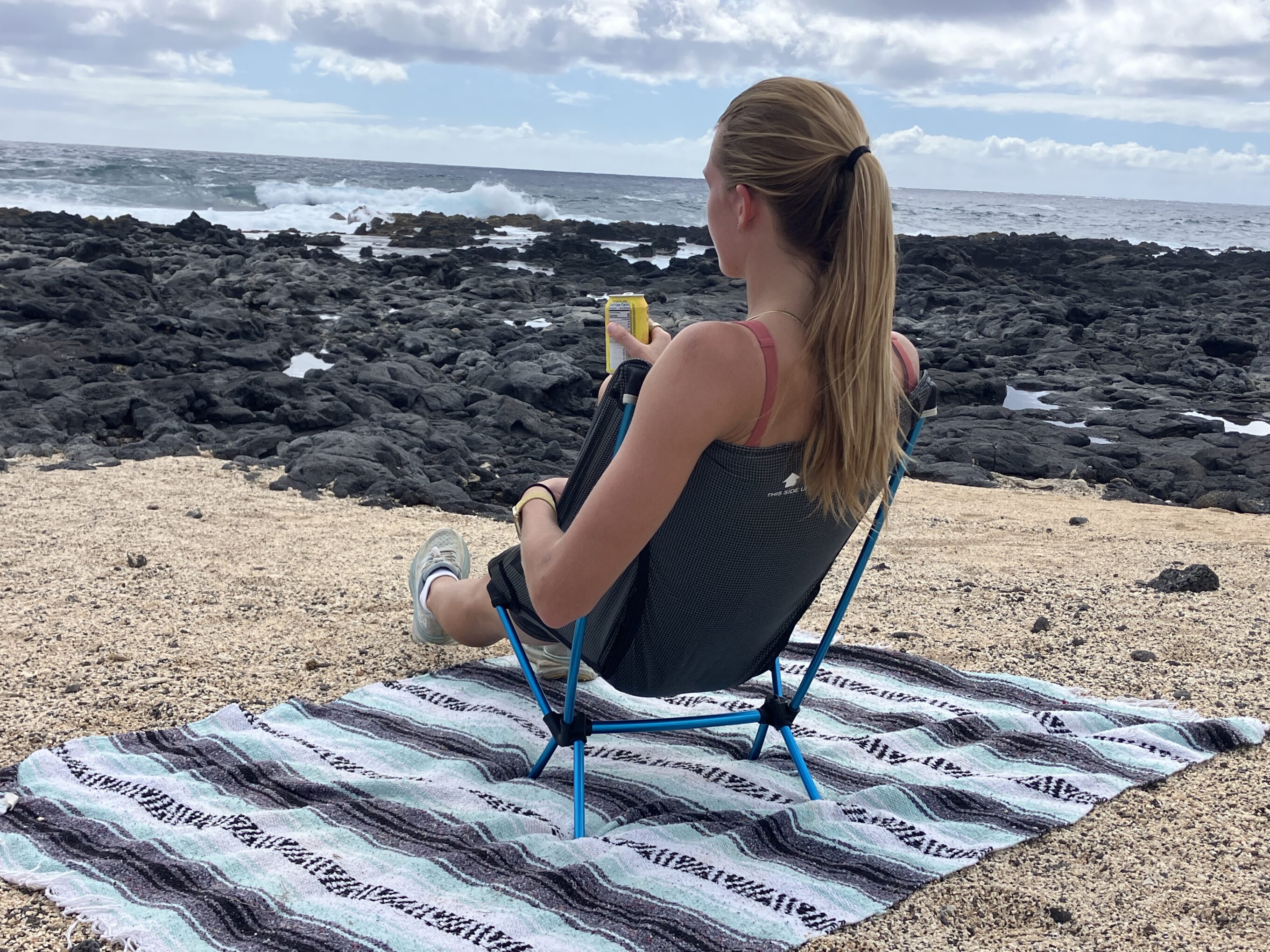 women sitting in the Helinox Chair Zero at the beach.