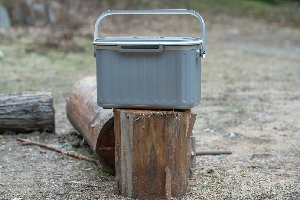 The Oyster tempo cooler sitting on a log in the forest