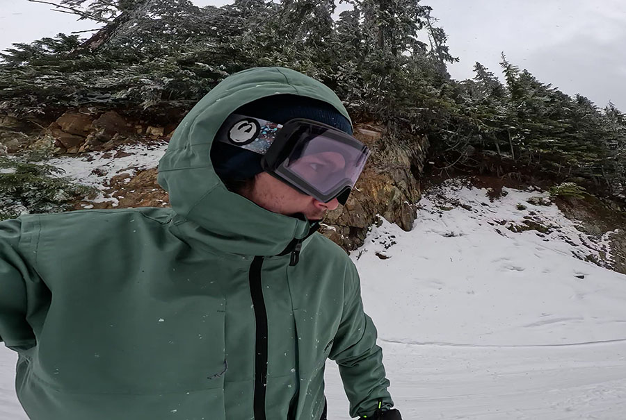 a snowboarder with a 686 smarty 3 in 1 jacket and dragon goggles