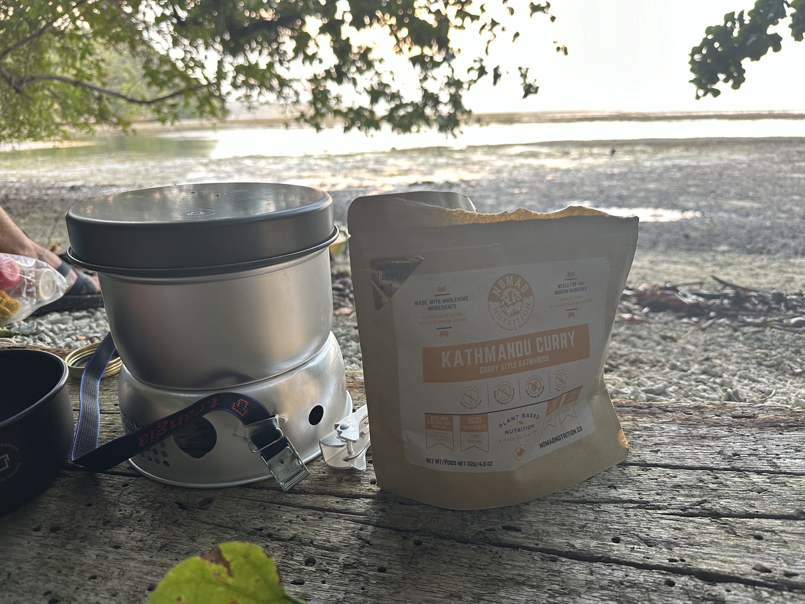 a backpacking meal and a stove on the beach