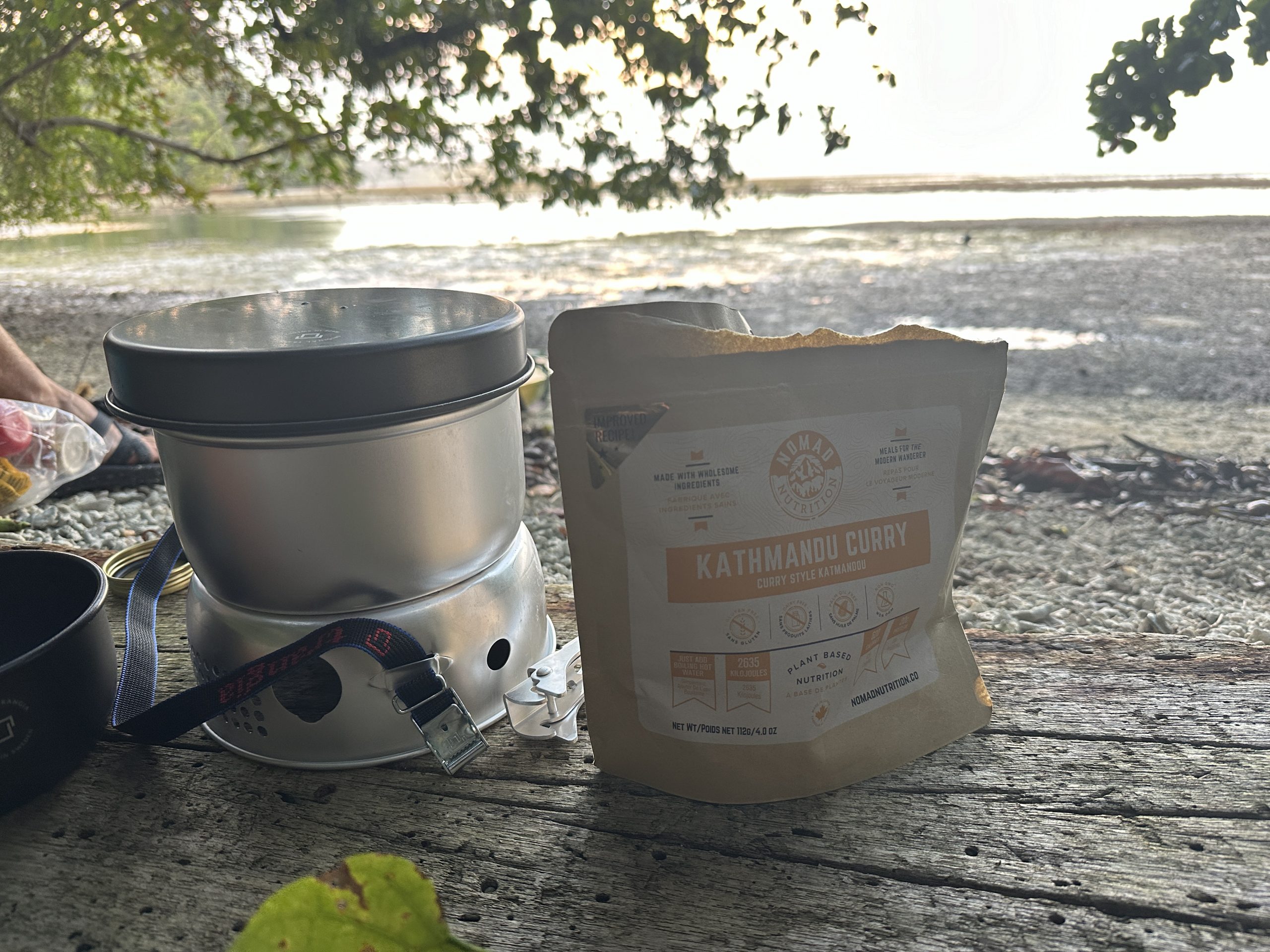 a backpacking meal and a stove on the beach