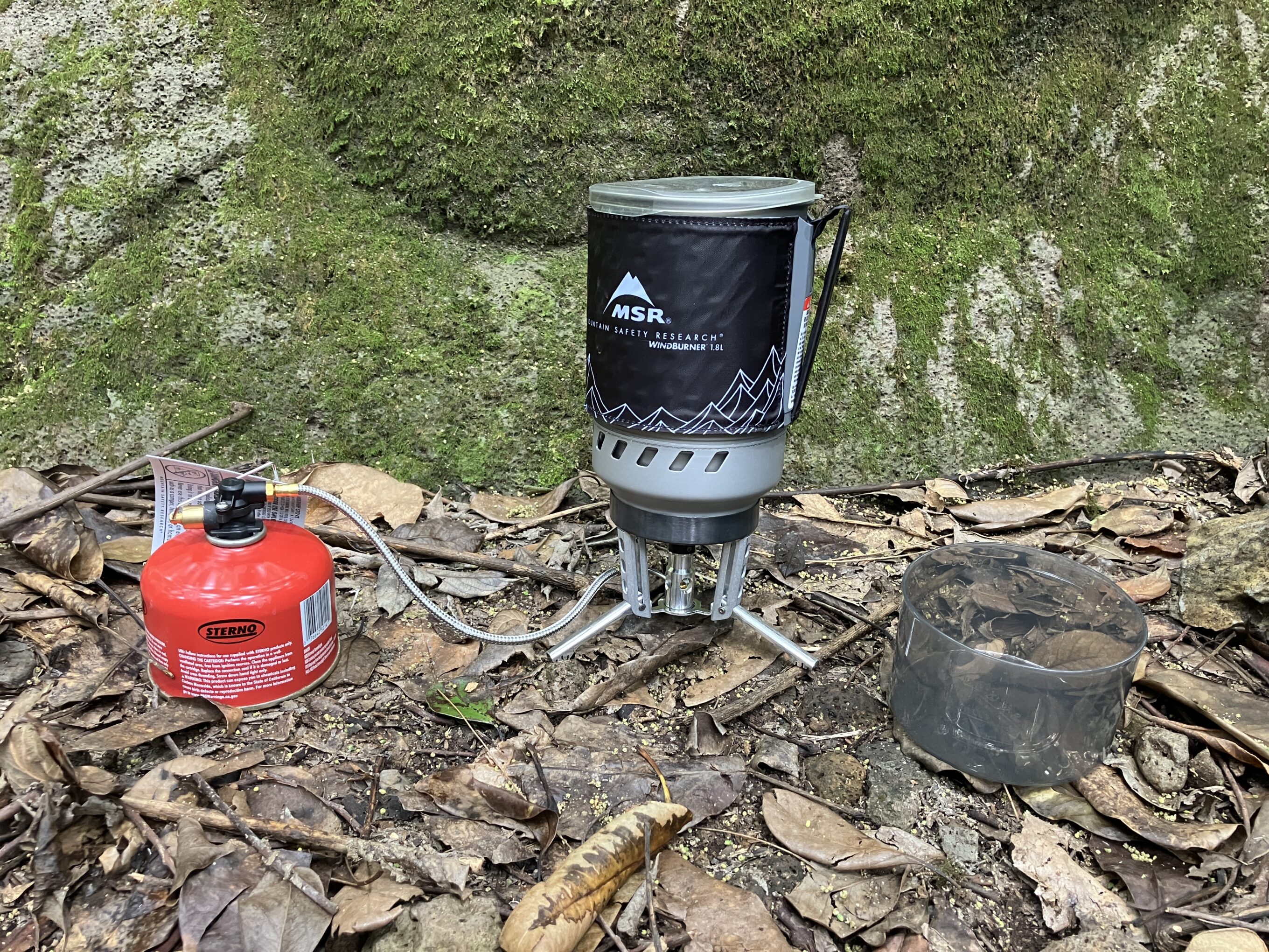 a MSR backpacking stove set up on the ground, one of the backpacking stoves we tested for this guide