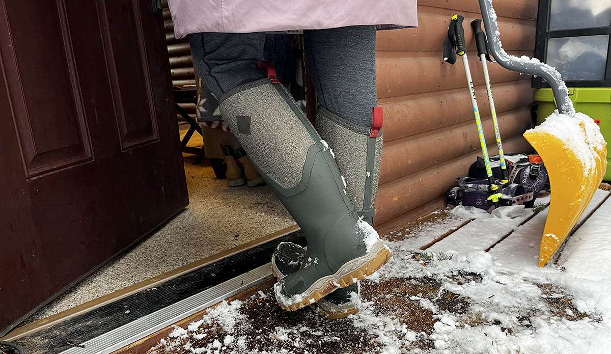 Muck Boot Women's Arctic Sport II Tall Boot walking into cabin