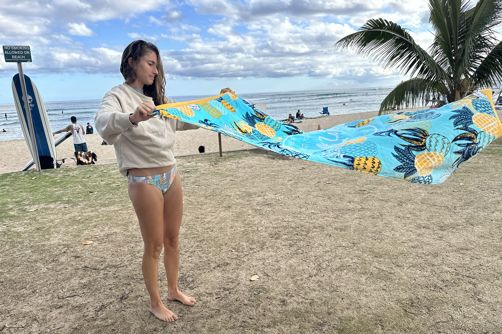 woman laying out a beach towel at the beach 