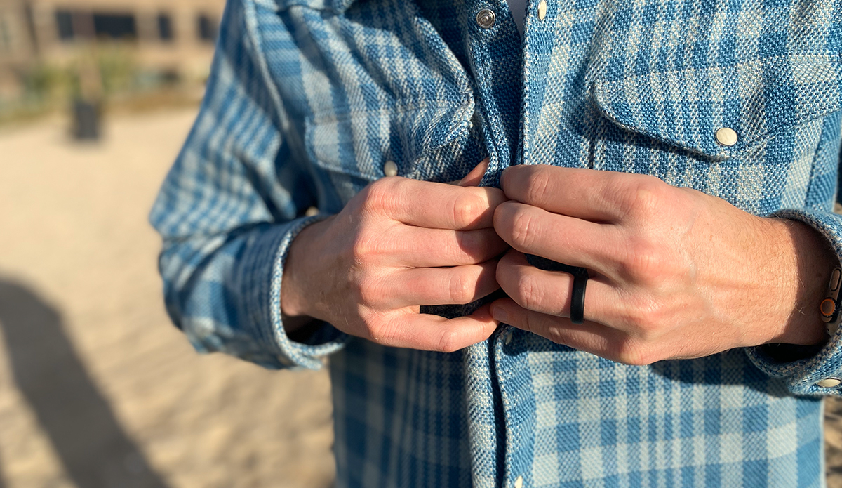 a man buttons up one of the flannel shirts used in this guide