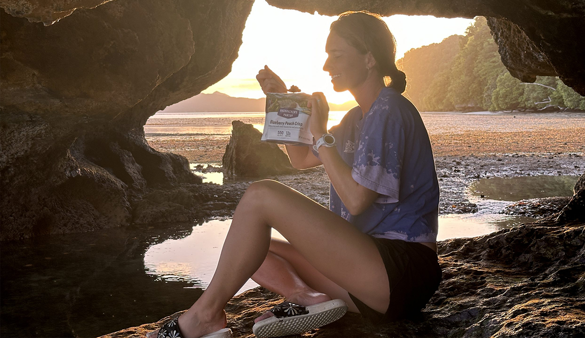 a woman eats one of the backpacking meals she tested for this guide