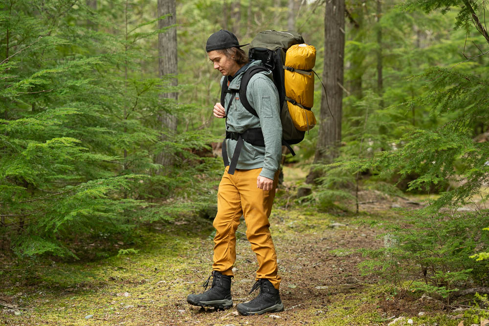 a hiker in the forest with the Oboz Bangtail Mid winter hiking boots