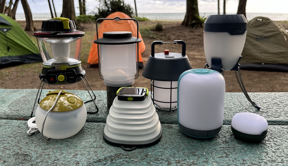 a bunch of camping lanterns sitting on a table
