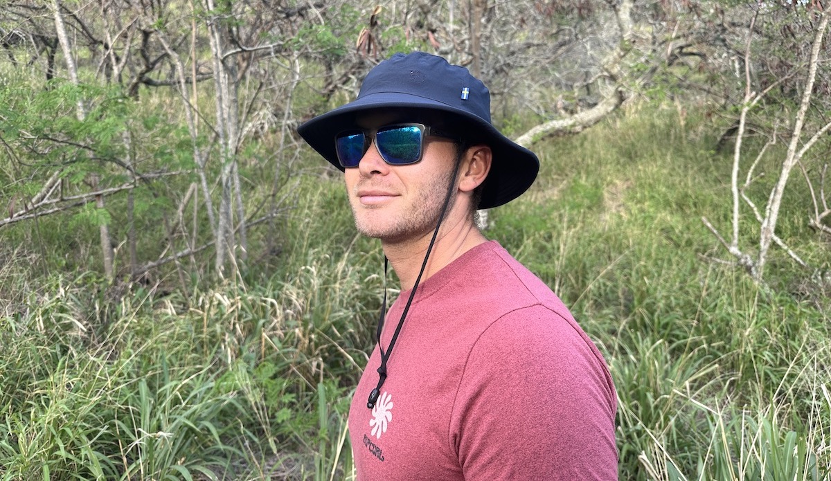 a man wearing a sun hat on a hike