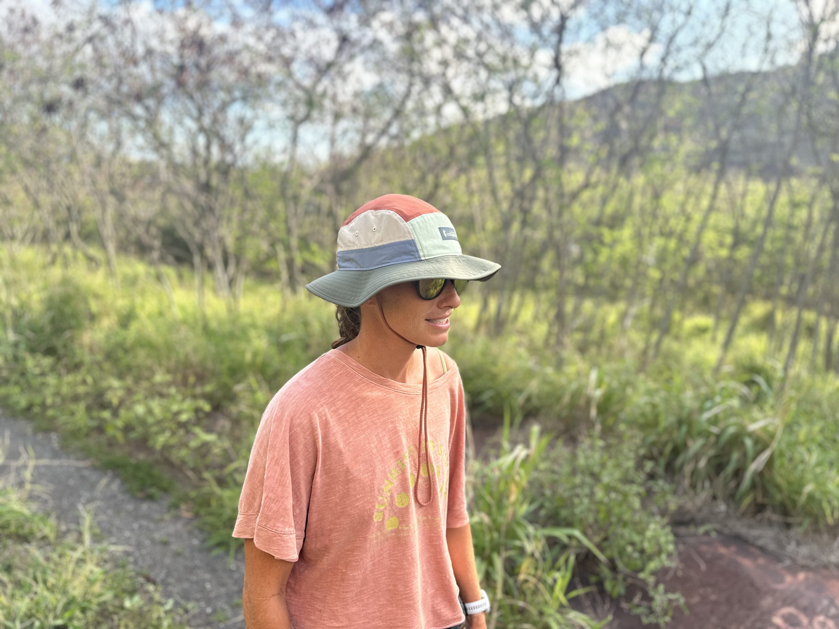 a woman hiking wearing a sun hat