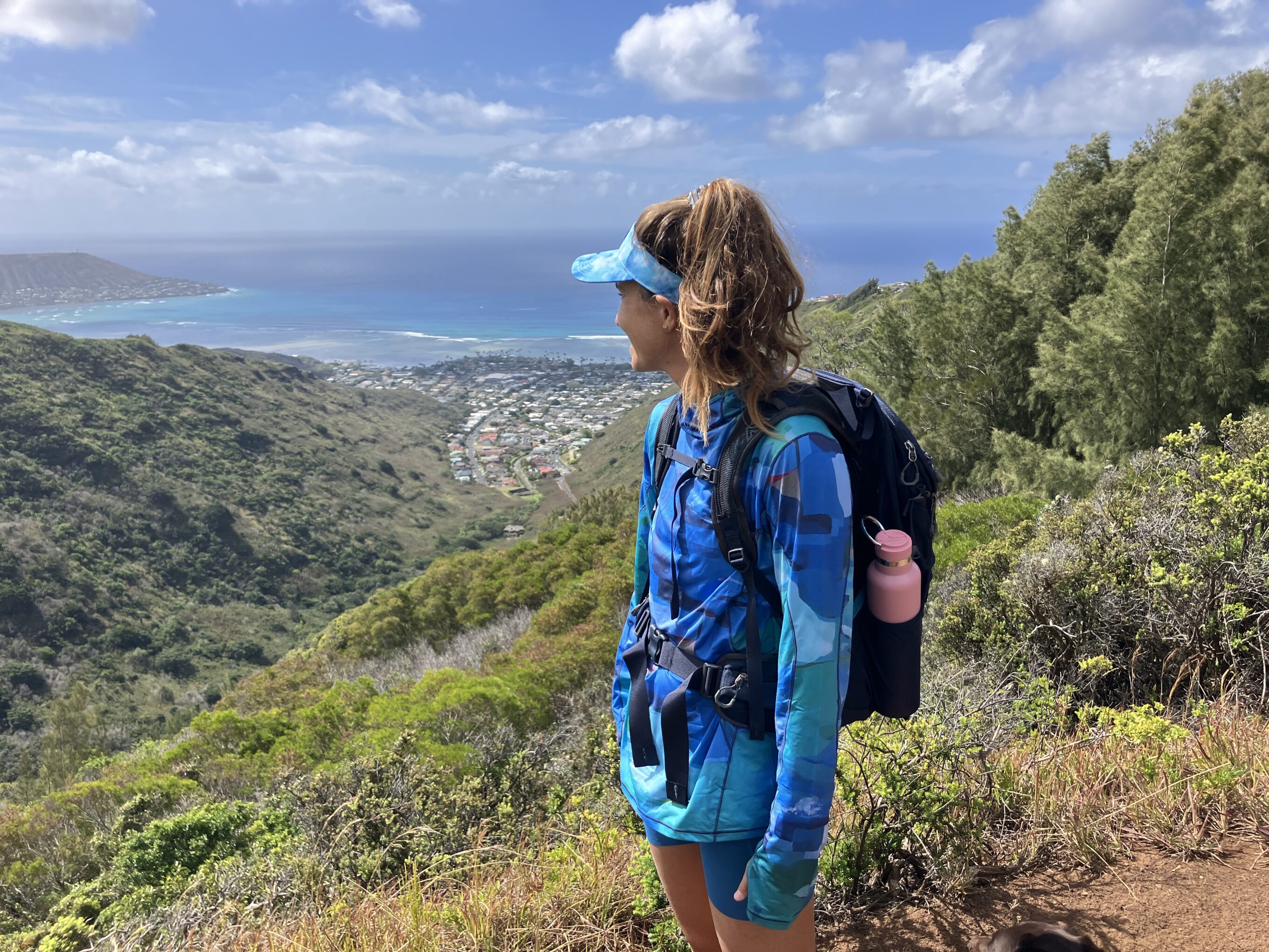 a woman wearing sun shirts on a hike