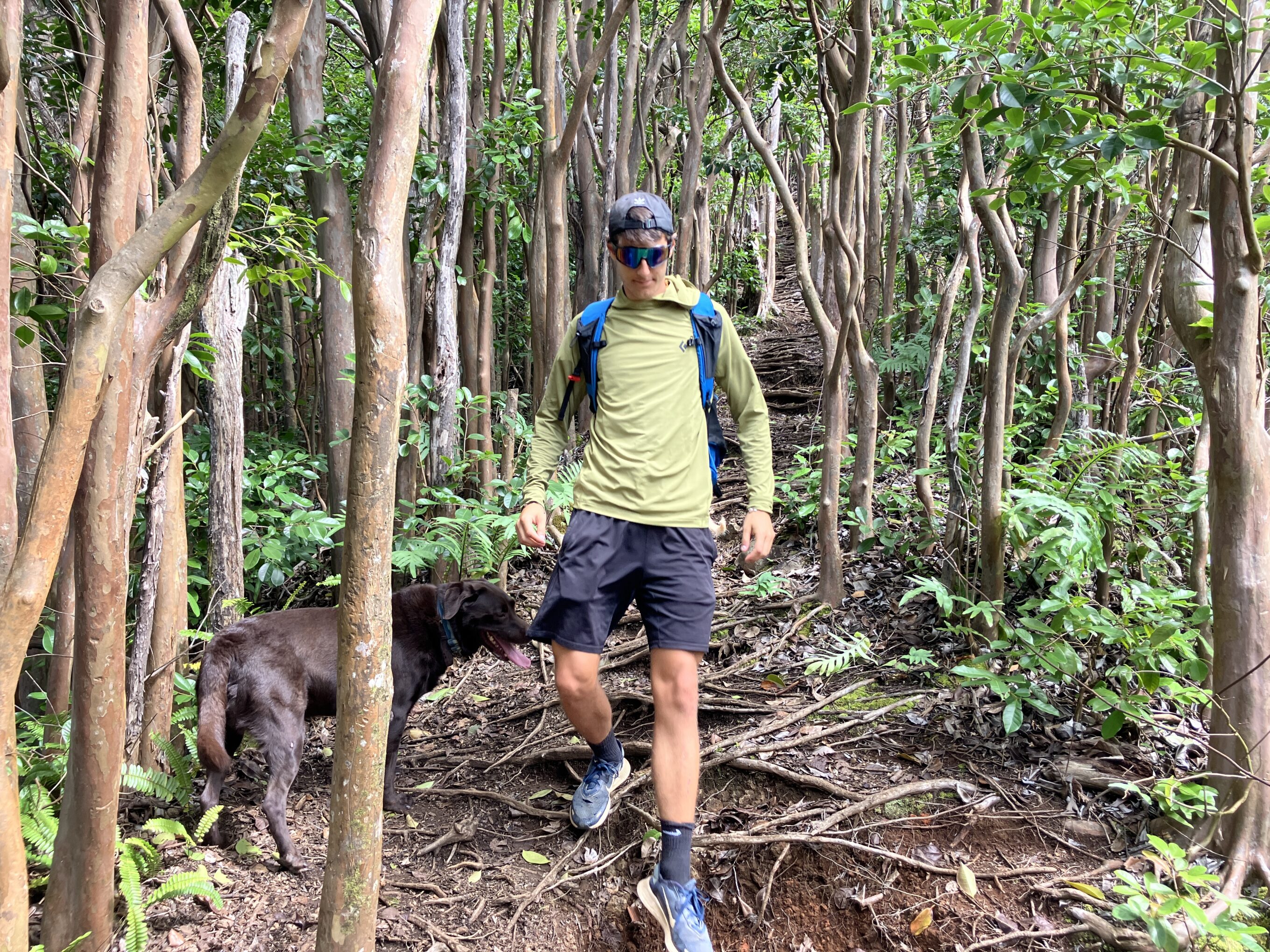 a man hiking in the forest in a sun shirts